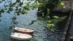 two small boats are docked in the water