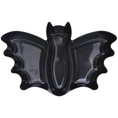 a black glass bat shaped dish on a white background