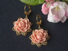 Filigree flower shaped brass bases have coral pink coloured roses attached. Shell adorned brass lever backs finish the look. In the Victorian language of flowers coral coloured roses meant desire. Limited edition design. Brass lever backs. Length (from top of ear wire to bottom of earring) 3.7cm (1.45 inches). For more beautiful and unusual handmade earrings please visit: www.etsy.com/uk/shop/HandmadeEarringsUk Vintage Rose Gold Flower Earrings, Vintage Brass Flower Earrings, Vintage Pink Nickel-free Flower Earrings, Vintage Rose Gold Flower Earrings Gift, Rose Gold Vintage Flower Earrings For Gift, Handmade Vintage Rose Gold Earrings, Vintage Rose Gold Flower Earrings For Wedding, Victorian Language Of Flowers, Victorian Language