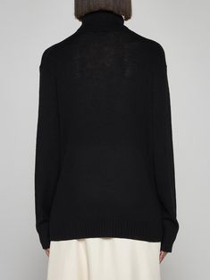 100% wool Elegant Black V-neck Sweater For Work, Luxury Wool Sweater For Work, Formal Fine Knit Merino Wool Sweater, Elegant Black Fine Knit V-neck Sweater, Luxury Merino Wool Sweater For Work, Luxury Merino Wool Sweater For Formal Occasions, Luxury Merino Wool Workwear Sweater, Luxury Wool Sweater For Layering, Luxury Wool Tops For Fall