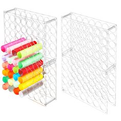 two clear bins with pens and markers in them on the same side, one is filled with crayons