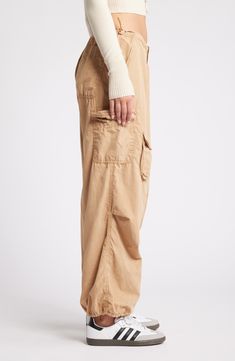 These Y2K-inspired cargo pants feature a baggy low-rise silhouette, plenty of pockets and a toggle-adjustable waist. 29 1/2" inseam; 12" leg opening; 10" front rise; 14 1/2" back rise (size medium) Exclusive retailer Zip fly with hook-and-bar closure Drawcord-toggle waist Front slant pockets; back patch pocket; cargo flap-patch and flap-bellows pockets 100% cotton Machine wash, line dry Made in Turkey Loosely Fitted Straight Leg Cargo Parachute Pants, Utility Wide Leg Parachute Pants With Relaxed Fit, Relaxed Fit Wide Leg Utility Parachute Pants, Relaxed Fit Wide-leg Utility Cargo Pants, Relaxed Fit Full Length Parachute Pants With Pockets, Utility Straight Leg Parachute Pants With Cargo Style, Relaxed Fit Straight Leg Parachute Pants With Cargo Pockets, Utility Straight Leg Cargo Style Parachute Pants, Baggy Full-length Utility Parachute Pants