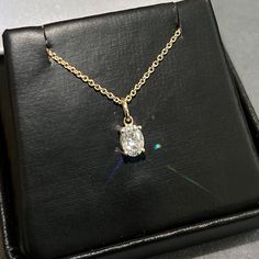 Moissanite offers timeless beauty and exceptional value. This beautiful pendant and chain set features a GRA certified VVS1 clarity D color Moissanite hand set by our master jewelers on a durable 14K gold setting. This is the best compromise between cheap fakes (CZ, crystal, rhinestone) and an extremely expensive diamond. Natural diamond equivalent stones cost $10,000 - $100,000+. Get the same look at a reasonable price. Necklace can be worn at 16, 17, and 18 inch lengths. Order yours today! -Best of Breed VVS1 Clarity D color GRA certified Moissanite Stones -Exceptionally Cut for ideal light refraction. Excellent Rating.  -More Fire and Brilliance than Cheap Priced Moissanite online -Solid 14K gold for the best balance of beauty and durability. Choose yellow gold, white gold, 925 silver o Classic Oval Solitaire Necklace Gift, Classic Oval Solitaire Necklace For Gift, Oval Pendant Jewelry With Single Diamond, Oval Solitaire Necklace With Prong Setting For Anniversary, Formal Solitaire Necklace With Oval Cubic Zirconia Pendant, Oval Solitaire Necklace With Single Diamond As Gift, Oval Solitaire Necklace With Single Diamond, Formal Cubic Zirconia Solitaire Necklace With Oval Pendant, Formal Oval Pendant Solitaire Necklace