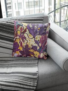 a gray couch with colorful pillows on it