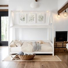 a white bunk bed sitting on top of a hard wood floor