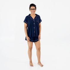 Woman wearing Kyte Baby Women's Short Sleeve Pajama Set in Navy with Cloud Trim Casual Cotton Nursing-friendly Sleepwear, Family Matching Cotton Sleepwear, Family Matching Cotton Sleepwear For Loungewear, Comfortable Nursing-friendly Sleepwear, Blue Short Sleeve Matching Sleepwear Set, Relaxed Fit Matching Sleepwear Set For Sleepovers, Nursing-friendly Relaxed Fit Sleepwear, Relaxed Fit Nursing-friendly Sleepwear, Family Matching Loungewear Sets With Short Sleeves