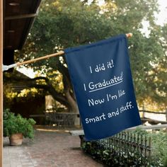 a blue banner hanging from the side of a building with congratulationss written on it