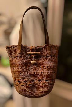 This beautiful retro granny square bag is designed for a unique and stylish look, The bag is hand-knitted with high quality cotton fibers. Beautiful chocolat color ,this crochet bag is perfect for all day use . With an elegant and durable structure, the bag will complement any outfit and highlight your style. For the closure of the bag I placed a small sea wood and a stone from the beach of the city where I live, in Crete, Greece Bag is not lined  . A perfect gift option for your loved ones. Bag Bohemian Brown Bucket Bag With Double Handle, Vintage Style Natural Color Crochet Bag, Bohemian Brown Crochet Bag For Travel, Bohemian Straw Satchel Bag, Bohemian Brown Beach Bag For Everyday, Vintage Style Everyday Crochet Bag In Natural Color, Bohemian Satchel Straw Bag With Handles, Bohemian Straw Satchel With Handles, Bohemian Straw Satchel Bag With Handles