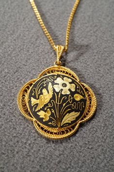 I am offering this fabulous vintage yellow gold tone necklace. This piece is truly gorgeous, and it has the following features: * beautiful vintage necklace * yellow gold tone * jet black enameled * flower design * pendant measuring 1.5 inches in diameter * 19 inches in length This is a fantastic and classic piece. There is tons of sparkle and shine with this piece. It will beautifully complement your upcoming fashion season. Buyer pays all shipping and handling. Antique Yellow Gold Enamel Necklace, Yellow Gold Enamel Medallion Necklace, Victorian Enamel Yellow Gold Necklace, Victorian Yellow Gold Enamel Necklace, Victorian Style Yellow Gold Enamel Necklace, Antique Enamel Necklace With Hallmark, Formal Enamel Medallion Necklace, Antique Enamel Necklace Hallmarked, Antique Enamel Hallmarked Necklaces