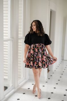 Elevate your style with our gorgeous Marta Dress! Featuring a stunning mix of black and floral fabrics, this dress boasts a boucle top and a contrasting woven skirt for a unique and eye-catching look. The empire waist and puff sleeves with tie detail add a touch of femininity and charm. Get ready to turn heads and feel confident in this must-have dress! Black Puff Sleeve Dress With Floral Print, Black Tiered Skirt Dress For Brunch, Black Tiered Skirt Dress For Spring, Black Tiered Skirt Dress For Day Out, Black Spring Puff Sleeve Casual Dress, Black Puff Sleeve Dress For Casual Spring Occasion, Floral Fabrics, Floral Fabric, Feel Confident