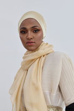 Its name speaks for itself, it’s very simple and elegant to allow you to match it with any outfit. Whether it’s a party gown or a stylish simple dress, this set is the right choice for you. This gorgeous gold turban is made with care and love and paired with either a 100% Cream Pure Soft Silk Shawl (28"x 72") or a Tulle Shawl (27"x72") for a more dramatic impact. You have the option to choose the look you’re looking for. Simply Gold Set is perfect for every occasion. You can dress it up for a so Tulle Shawl, Bridal Hijab, Party Gown, Simple Dress, Gold Satin, Silk Shawl, Party Gowns, Gold Set, Simple Dresses