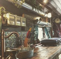 an old fashioned kitchen with wooden counter tops and metal faucets on the wall