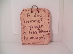 a plaque with words written on it that says, a day heimed in prayer is less likely to unravel