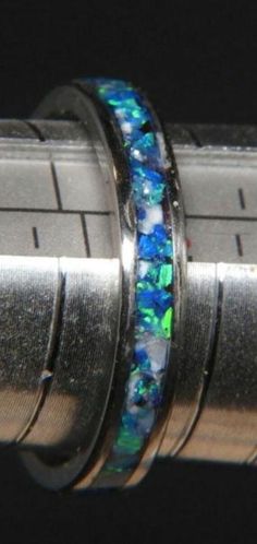 This is one of my newest creations and i'm very proud of how it looks. This ring is a size 9 but I can duplicate it in your size. Made on a  4mm stainless  ring blank with a 2mm inlay channel.  The inlay is different shades of blue  crushed opel,  all sealed in a clear resin and lathe turned, sanded and polished. this ring pictured is a size 9. Other sizes can be substituted for my chosen ring. Free shipping and ring presentation box included. Blue Crush, Ring Pictures, Christmas Deals, Clear Resin, Shades Of Blue, Band Rings, Favorite Jewelry, Hand Made, Jewelry Rings