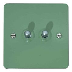 a light switch with three knobs and two switches on each side, in green