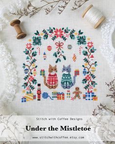 a cross stitch pattern with the words under the mistcote on it and two spools of thread next to it