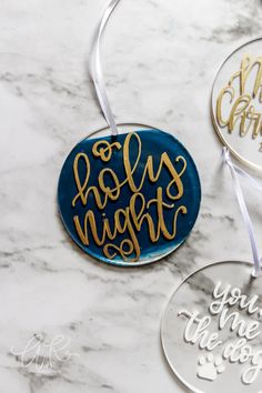 three christmas ornament ornaments on a marble table with the words merry and hug night