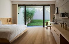 a bedroom with wooden floors and sliding glass doors