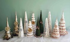 a group of small christmas trees sitting on top of a table