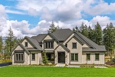 a large house in the middle of a lush green field