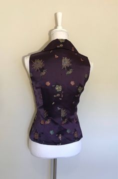 "vintage embroidered silk vest V-neck button down Boutique handmade Tailored fitted Lined in pristine condition size: S measures shoulder to shoulder: 13\" across the chest, arm pit to arm pit: 17\" Waist: 29\" length: 24\" Color: deep eggplant purple, gold, pink, blues, black Comes from smoke/pet free home condition: excellent vintage" Fitted Vintage V-neck Vest, Vintage Embroidered Fitted Vest, Fitted Vintage Vest With Embroidery, Traditional Fitted Vest For Fall, Traditional Fitted Fall Vest, Elegant Embroidered Sleeveless Vest, Vintage Fitted Embroidered Vest, Silk Fitted Vest For Formal Occasions, Fitted Floral Embroidered Vest For Fall