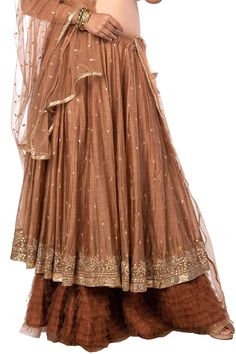 Brown layered lehenga with all-over gota floral motifs. Comes with blouse and net dupatta.
Component: 3
Pattern: Embroidery
Type Of Work: Gota
Neckline: V neck
Sleeve Type: Cap
Fabric: Chanderi and Net
Color: Brown
Other Details: 
Blouse with pleated detail on the hem
Embellished dupatta with lace border
Lehenga with tie up and tassels on the side
Closure: Side zip
Occasion: Wedding - Aza Fashions Eid Festival Long Skirt Set With Dupatta, Festive Set With Sheer Dupatta And Long Skirt, Eid Festival Set With Dupatta And Long Skirt, Festive Long Skirt Set With Sheer Dupatta, Anarkali Choli With Georgette Tiered Skirt, Festive Designer Anarkali Set With Long Skirt, Bollywood Style Choli With Zari Work And Tiered Skirt, Anarkali Wedding Sharara With Tiered Skirt, Anarkali Sharara With Tiered Skirt For Wedding