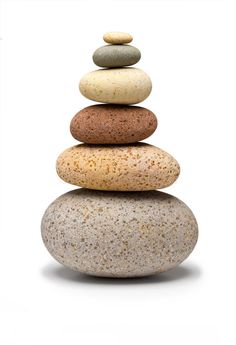 a stack of rocks sitting on top of each other in front of a white background