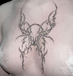 the back of a woman's breast with vines on it