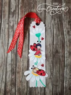 the bookmark is decorated with ladybugs and daisies