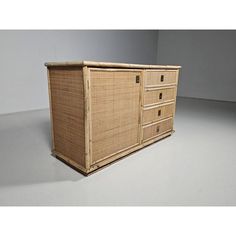 a wicker dresser with four drawers on one side and two doors on the other