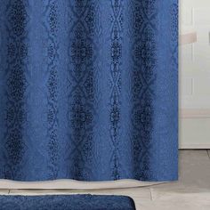 a blue shower curtain in a bathroom