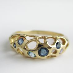 When the tide recedes, even the smallest community surrounds you with the biggest support. Blue sapphires, blue topaz, aquamarine. Measures approximately 7mm at widest point. Modern Blue Sapphire Ring In 14k Gold, Unique Blue Multi-stone Sapphire Ring, Blue Multi-stone Sapphire Ring In 14k Gold, Gold Multi-stone Blue Topaz Ring, Unique Multi-stone Blue Topaz Ring, Gold Blue Topaz Multi-stone Ring, Unique Blue Sapphire Ring With Accent Stones, Modern Blue Topaz Ring In 14k Gold, Unique Blue Multi-stone Topaz Ring