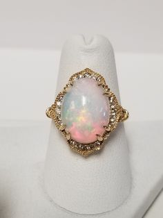 "Thanks for shopping our vintage estate store. We tend to sell well below wholesale and truly hope you enjoy all of our items. Many of the items are one of a kind, so please enjoy scrolling through the pictures and hopefully something will catch your eye. Brown spots are from the camera or reflections. Estate 14k yellow gold natural 4.5ct oval opal .20ct diamond cocktail ring. There are 20 diamonds, and they are nice and bright. Ring size: 6.5 Setting: 5/8\" by 3/4\" Sits up: 3/8\" Gem: 9mm by 11mm Band width: 2mm Weight: 5.17 grams Just stunning ring, one of the prettiest I have seen lately. Marked 14k. As with most estate items there may be some wear on ring. We do not sell new rings, nor do we charge new retail prices." Vintage 14k Stamped Opal Ring For Formal Occasions, Formal Oval Cabochon Diamond Ring, Fine Jewelry Oval Cabochon Diamond Ring, Heirloom Oval Cabochon Diamond Ring For Formal Occasions, Heirloom Oval Diamond Ring For Formal Occasions, Formal Heirloom Oval Cabochon Diamond Ring, White Oval Diamond Ring For Collectors, Oval Cabochon Diamond Opal Ring, Antique Oval Hallmarked Diamond Ring