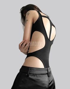 Type: Techwear bodysuit Design: Street Goth Ultra-resistant crop top: Designed with the best materials for a comfortable wear. Breathable materials: This bodysuit is made of polyester, spandex and nylon. Suitable for women Machine washable: 30 °C (86 °F) Size(cm | in) Bust Waist S 70-83 65-78 M 74-87 69-82 L 78-91 73-86 Black Streetwear bodysuit Meticulously designed for the fashion-forward individual, this bodysuit stands as a testament to the boldness inherent in the techwear aesthetic. The bodysuit contours to your silhouette, offering a seamless, second-skin fit that moves with you. Its high-stretch material accommodates a full range of motion, making it an impeccable choice for a day's journey. The bodysuit's cut-out design isn't just a nod to the avant-garde; it's a functional featur Fitted Black Futuristic Bodysuit, Futuristic Fitted Bodysuit For Night Out, Stretch One-piece Bodysuit For Club, Bodycon Elastane Bodysuit For Club, Futuristic Bodysuit For Club, High Stretch Elastane Backless Bodysuit, Futuristic Club Bodysuit, Black Bodysuit With Built-in Bra For Club, High Stretch Nylon One-piece Bodysuit