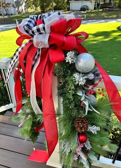 a christmas wreath on top of a wooden bench