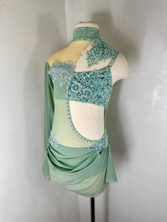 a green and white dress on a mannequin