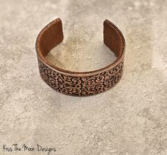 Discover Elegance with the Wide Floral Copper Cuff Embrace timeless beauty and artisanal craftsmanship with our Wide Floral Copper Cuff. Handcrafted using antique rolling plates from the renowned Frank Morrow Cranston Fancy Wire Company, a legacy dating back to 1867, this bracelet is not just an accessory—it's a piece of history. Features You'll Love: Stunning Floral Design: The intricate patterns of flowers, accompanied by scrolled stems and leaf accents, make this cuff a true statement piece. Addisons Disease, Copper Cuff, Copper Bracelet, Moon Design, Intricate Patterns, Timeless Beauty, Shop Earrings, Necklaces Bracelets, Floral Design