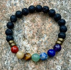 Enhance your energy and style with our Handmade Unisex Chakra Bracelet! Crafted with premium gemstones and 8mm black lava stone beads, this unique piece offers both beauty and balance. The clear stretch cord ensures a comfortable fit on an average wrist size of 7 inches.  Why You'll Love It: - **Holistic Healing Each gemstone is carefully selected to align and balance your chakras, promoting inner peace and well-being. - **Quality Craftsmanship Handmade in the USA with meticulous attention to de Spiritual Lava Stone Beaded Bracelets With 8mm Beads, Black Holistic Beaded Bracelets With Natural Stones, Black Lava Stone Spiritual Beaded Bracelets, Black Lava Stone Bracelets With Gemstone Beads, Holistic Black Beaded Bracelet With Natural Stones, Black Round Beads Bracelets Holistic Style, Holistic Black Bracelets With Round Beads, Black Holistic Round Beaded Bracelets, Black Lava Stone Bracelet With Gemstone Beads