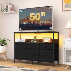 a flat screen tv sitting on top of a wooden dresser