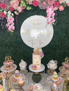 a table topped with lots of cakes and cupcakes