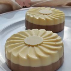 two desserts sitting on top of a white plate