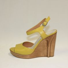 Yellow Leather Maison Martin Margiela Paris Peep-Toe Wedge Sandals With Wooden Heels. Stiletto Heel Design Carved Into Side Of Wood Wedge. Beautiful White Stitch On Heel Strap. New Without Tags. Never Been Worn. Super Rare! Perfect Unused Condition. Made In Italy Marked Sized 38 1/2 Would Best Fit Us Size 7.5-8 4.75-Inch Heel 1-Inch Platform Chic Yellow Leather Wedge Sandals, Chic Yellow Heels With Heel Loop, Yellow Leather Wedge Sandals For Summer, Yellow Closed Toe Platform Heels, Yellow Sandals With Wooden High Heel, Yellow High Heel Sandals With Wooden Heel, Yellow Platform High Heels, Yellow Heels With Wooden High Heel, Yellow High Heels With Wooden Heel