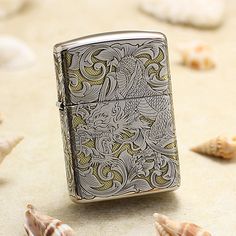 a lighter sitting on top of a table next to sea shells