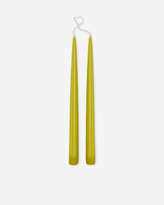 two yellow candles sitting next to each other