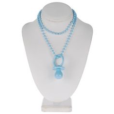 a white mannequin with a blue necklace on it