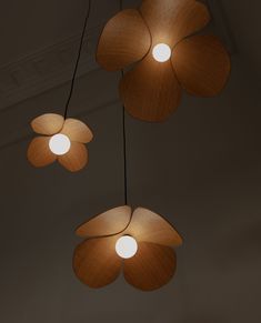 three flower shaped lights hanging from the ceiling