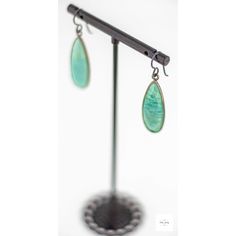 Indulge in the beauty of the ocean with these stunning, shimmering seafoam green and aqua blue Amazonite drop earrings. The bright bright Amazonite perfectly complements the gray niobium ear wires, creating a mesmerizing contrast of colors. Be charmed by the alluring beauty of these limited edition sea green amazonite drop earrings. Each gemstone features a unique striated pattern in shades of aqua blue, sea green, lemon yellow, and white, reminiscent of the ocean's natural beauty. Measuring 1 i Amazonite Drop Earrings As Gift, Dangle Earrings With Amazonite And Natural Stones, Amazonite Natural Stone Earrings For Gifts, Green Jade Earrings For Healing, Turquoise Amazonite Dangle Earrings, Turquoise Dangle Earrings With Amazonite, Handmade Turquoise Amazonite Earrings, Bohemian Amazonite Earrings For Gifts, Bohemian Amazonite Earrings As Gift