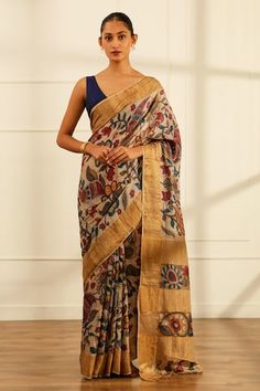 Cream saree featuring kalamkari patterned floral and foliage motifs highlighted by woven golden border and palla. Comes with unstitched blouse fabric. - Aza Fashions Traditional Pre-draped Saree With Floral Print, Traditional Art Silk Pre-draped Saree With Floral Print, Traditional Multicolor Pre-draped Saree With Floral Print, Festive Kalamkari Print Pre-draped Saree In Slub Silk, Traditional Pre-draped Saree With Printed Motifs For Diwali, Bollywood Style Festive Pre-draped Saree With Kalamkari Print, Pre-draped Tussar Silk Saree With Kalamkari Print, Traditional Pre-draped Saree With Floral Print For Designer Wear, Festive Kalamkari Print Pre-draped Saree