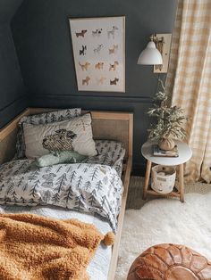 a bedroom with a bed, rugs and pictures on the wall