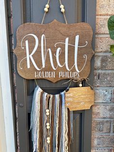 a wooden sign hanging on the side of a door